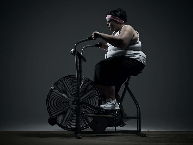 Overweight woman on exercise bike